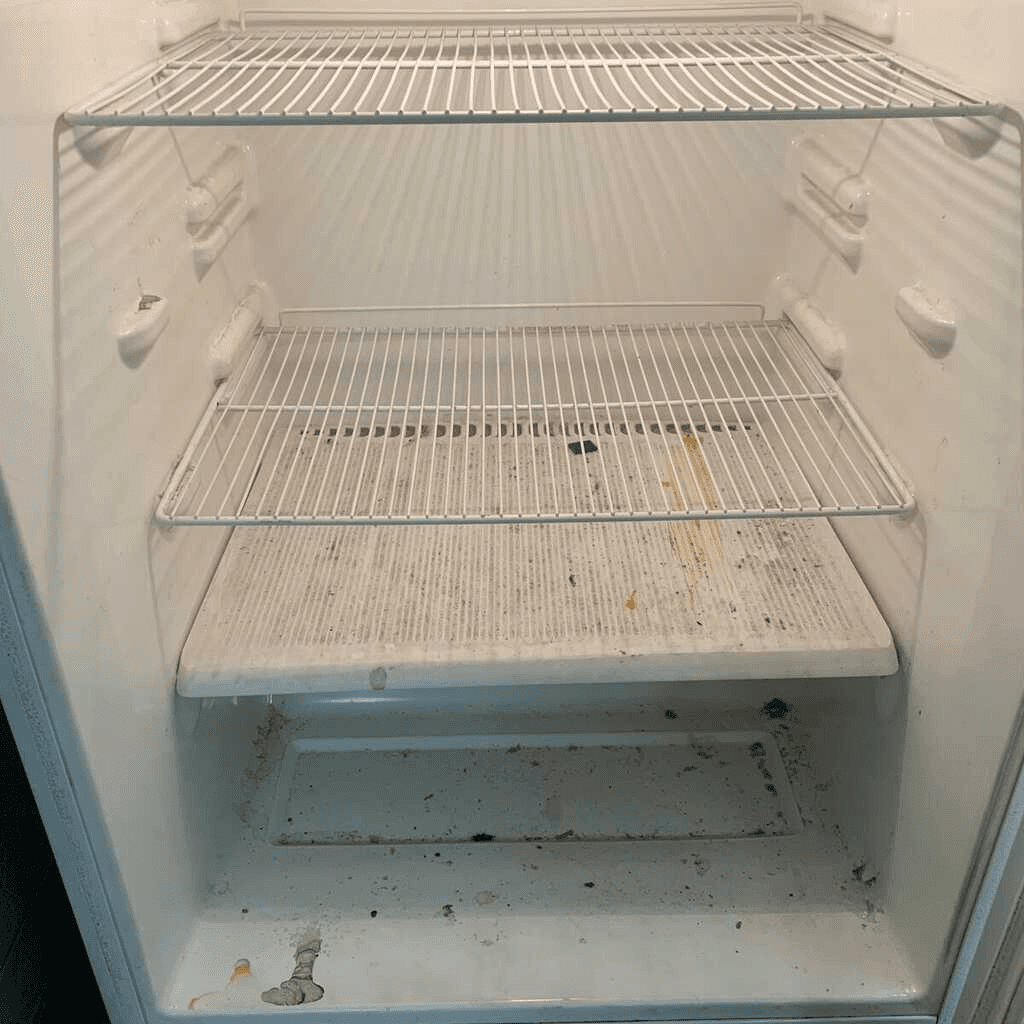 Dirty refrigerator interior before deep clean
