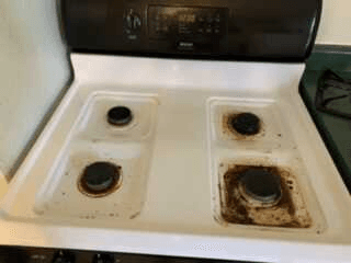 Greasy white stovetop before house cleaning