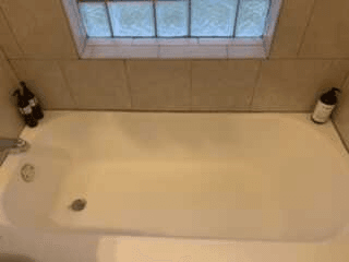 Bright white bathtub after house cleaning