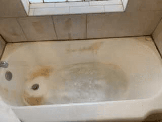 Stained bathtub before bathroom deep cleaning