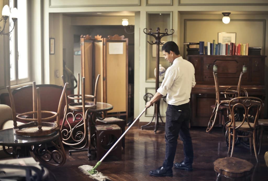 Commercial floor cleaning in a restaurant after hours with professional mop equipment